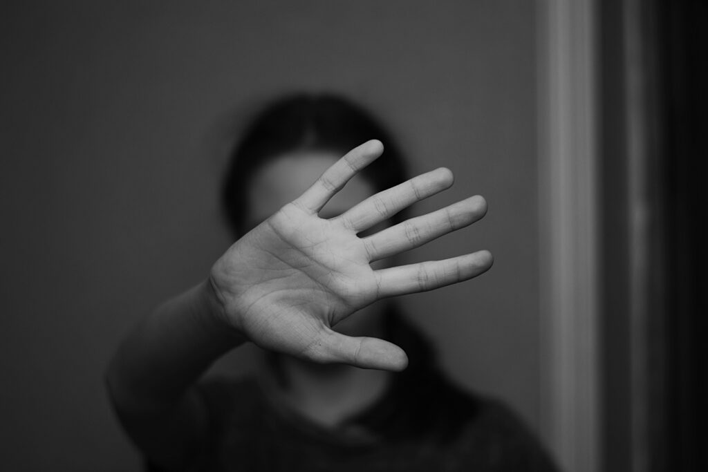 Fille avec main devant visage